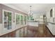 Open kitchen and living room featuring hardwood floors, island, stainless steel appliances, and natural light at 10660 Dunoon Dr, Alpharetta, GA 30022