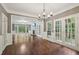 Spacious living room with fireplace, hardwood floors, and French doors leading to the deck at 10660 Dunoon Dr, Alpharetta, GA 30022