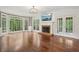 Spacious living room features fireplace, hardwood floors, and picture windows at 10660 Dunoon Dr, Alpharetta, GA 30022