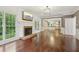 Bright living room with fireplace, large windows, hardwood floors, and open floor plan at 10660 Dunoon Dr, Alpharetta, GA 30022
