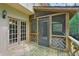 Cozy screened porch with wooden railings and access to both inside and the deck at 10660 Dunoon Dr, Alpharetta, GA 30022
