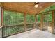 The screened-in porch features a wood ceiling and view of a lush, green backyard at 10660 Dunoon Dr, Alpharetta, GA 30022