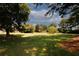 Expansive backyard featuring lush green grass, mature trees and plenty of space for outdoor activities at 1199 Ashborough Se Dr # K, Marietta, GA 30067