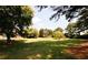 Expansive backyard featuring lush green grass, mature trees and plenty of space for outdoor activities at 1199 Ashborough Se Dr # K, Marietta, GA 30067
