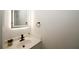 Modern half bath with a sleek vanity, backlit mirror, and contemporary fixtures at 1199 Ashborough Se Dr # K, Marietta, GA 30067