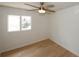 Cozy bedroom with hardwood floors, ceiling fan, and large window providing natural light at 1199 Ashborough Se Dr # K, Marietta, GA 30067