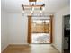 Bright dining room with wood floors, industrial lighting, and patio access at 1199 Ashborough Se Dr # K, Marietta, GA 30067