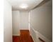 Hallway with hardwood floors and white walls at 1199 Ashborough Se Dr # K, Marietta, GA 30067
