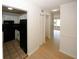 Hallway view shows hardwood flooring, storage closets, and access to the kitchen at 1199 Ashborough Se Dr # K, Marietta, GA 30067