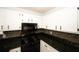 Close-up of kitchen featuring granite countertops, modern appliances, and white cabinets at 1199 Ashborough Se Dr # K, Marietta, GA 30067