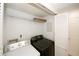 Efficient laundry area boasts a modern washer and dryer, upper storage, and easy access at 1199 Ashborough Se Dr # K, Marietta, GA 30067