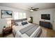 Stylish main bedroom features modern furniture, ceiling fan and bright natural light at 1199 Ashborough Se Dr # K, Marietta, GA 30067