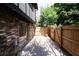 Back patio featuring brick wall, wood fence, and sliding glass door at 1199 Ashborough Se Dr # K, Marietta, GA 30067