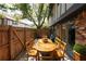 Brick patio with a wood dining table and chairs, with sliding glass door at 1199 Ashborough Se Dr # K, Marietta, GA 30067