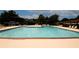 Large community pool with clear water surrounded by lounge chairs at 1199 Ashborough Se Dr # K, Marietta, GA 30067