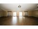 Spacious recreation room featuring new flooring, neutral paint, and access to the exterior at 1199 Ashborough Se Dr # K, Marietta, GA 30067