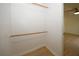 Bright walk-in closet with wood trim features a wood bar for hanging clothes at 1199 Ashborough Se Dr # K, Marietta, GA 30067
