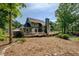 Backyard with sprawling wooden deck, lush landscaping and green exterior at 1391 Sutters Dr, Lawrenceville, GA 30045