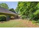 Landscaped backyard features privacy fencing, mature plantings and a shaded gazebo at 1391 Sutters Dr, Lawrenceville, GA 30045