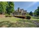 Expansive backyard with wooden deck and lush trees surrounding at 1391 Sutters Dr, Lawrenceville, GA 30045