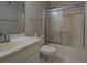 Bathroom features a shower and tub combination, a single sink, mirror, and tile floor at 1391 Sutters Dr, Lawrenceville, GA 30045