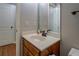 Bathroom features a single sink, mirror, and hardwood floor, as well as a connecting door at 1391 Sutters Dr, Lawrenceville, GA 30045