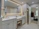 Bright bathroom featuring double sinks with granite counters, updated fixtures, and modern lighting at 1391 Sutters Dr, Lawrenceville, GA 30045