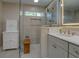 Bright bathroom featuring glass shower with modern fixtures and cabinetry for ample storage at 1391 Sutters Dr, Lawrenceville, GA 30045