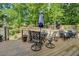 Outdoor deck features patio set and wooded view at 1391 Sutters Dr, Lawrenceville, GA 30045