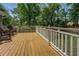 A spacious wooden deck features a white railing and overlooks the yard at 1391 Sutters Dr, Lawrenceville, GA 30045