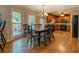 Bright dining area with hardwood floors, a modern chandelier, and access to the kitchen at 1391 Sutters Dr, Lawrenceville, GA 30045