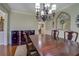 Chandelier hangs above a dining table with decorative mirror and buffet table displayed at 1391 Sutters Dr, Lawrenceville, GA 30045
