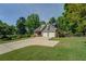 Charming home with a two-car garage, complemented by a lush lawn and mature trees at 1391 Sutters Dr, Lawrenceville, GA 30045