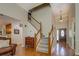 Welcoming foyer features hardwood floors, staircase, elegant chandelier, and high ceilings at 1391 Sutters Dr, Lawrenceville, GA 30045