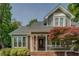 Welcoming front porch with brick accents and tasteful landscaping at 1391 Sutters Dr, Lawrenceville, GA 30045