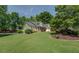 Well-manicured front yard featuring lush lawn and vibrant landscaping at 1391 Sutters Dr, Lawrenceville, GA 30045