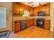 Modern kitchen with stainless steel appliances, granite countertops, and beautiful hardwood floors at 1391 Sutters Dr, Lawrenceville, GA 30045