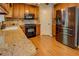 Kitchen featuring stainless steel appliances, granite countertops, tile backsplash, and ample cabinet space at 1391 Sutters Dr, Lawrenceville, GA 30045