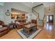 Open-concept living room featuring a staircase and seamless flow into the kitchen at 1391 Sutters Dr, Lawrenceville, GA 30045