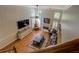 Aerial view of the living room showing the fireplace, TV, large windows and vaulted ceiling at 1391 Sutters Dr, Lawrenceville, GA 30045