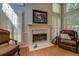 Cozy living room with a fireplace, plantation shutters, and plush seating at 1391 Sutters Dr, Lawrenceville, GA 30045