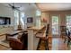 Open-concept living room with breakfast bar, hardwood floors, natural light, and comfortable seating at 1391 Sutters Dr, Lawrenceville, GA 30045