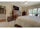 Main bedroom featuring neutral tones, carpet, and a large dresser with television at 1391 Sutters Dr, Lawrenceville, GA 30045