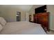 Main bedroom with neutral tones, plush carpet, and a large dresser with television at 1391 Sutters Dr, Lawrenceville, GA 30045