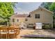 Inviting backyard with a stone patio, stainless steel grill, and a manicured lawn at 441 Amy Blvd, Temple, GA 30179