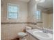 This bathroom features decorative tile, a window over the toilet, and a sink with vanity at 441 Amy Blvd, Temple, GA 30179