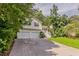 Charming two-story home featuring a two-car garage, manicured lawn, and mature trees at 441 Amy Blvd, Temple, GA 30179