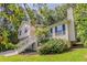 Charming two-story home with a manicured lawn and beautiful landscaping surrounded by trees at 441 Amy Blvd, Temple, GA 30179