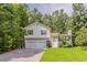 Charming split-level home featuring a two-car garage, and manicured lawn surrounded by mature trees at 441 Amy Blvd, Temple, GA 30179