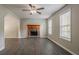 Spacious living room with wood-look floors, fireplace, neutral decor and archway to another room at 441 Amy Blvd, Temple, GA 30179